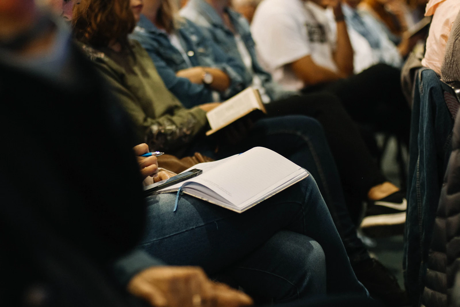 People seated together taking notes during a gathering